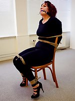 Redhead milf is chair-tied and ball-gagged